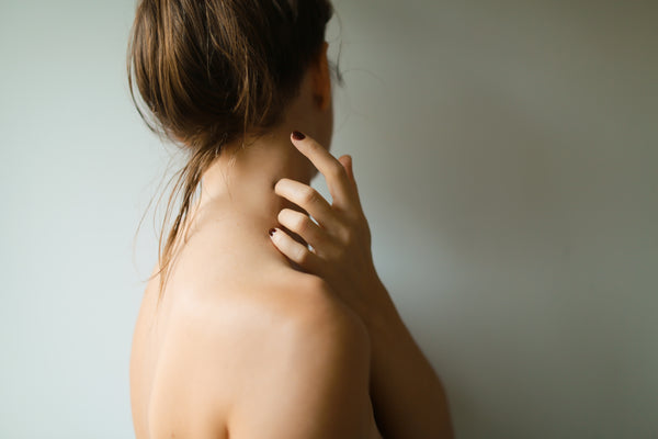 moisturized woman shoulder facing sideways