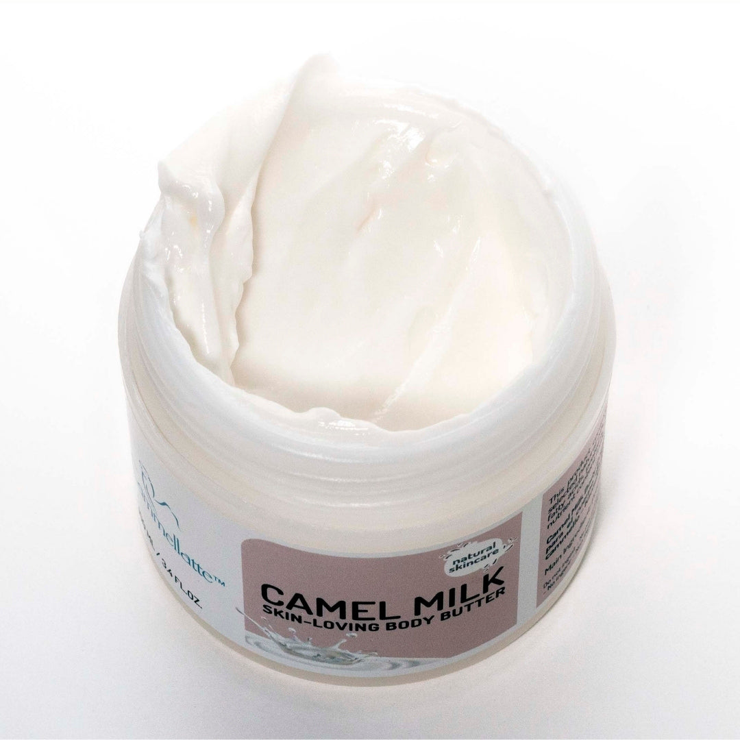An open jar of Cammellatte's Camel Milk Body Butter showcases its creamy, white texture and smooth consistency. Enriched with camel milk, this luxurious body butter offers a nourishing experience for your skin.