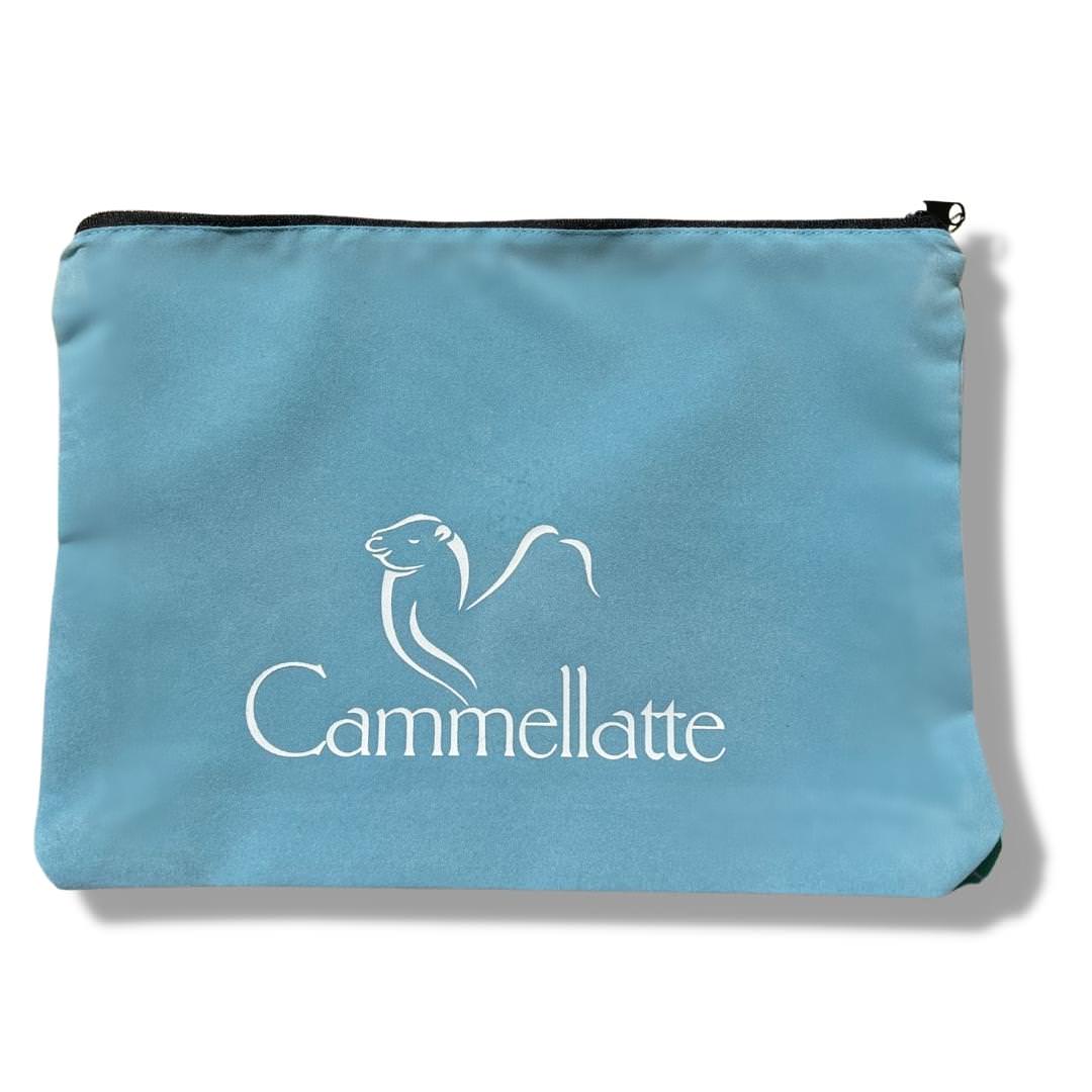 The Cammellatte Travel Pouch is a light blue zippered bag with a white logo and minimalist camel design above the brand name—ideal for transport and a stylish addition to your Cammellatte collection.